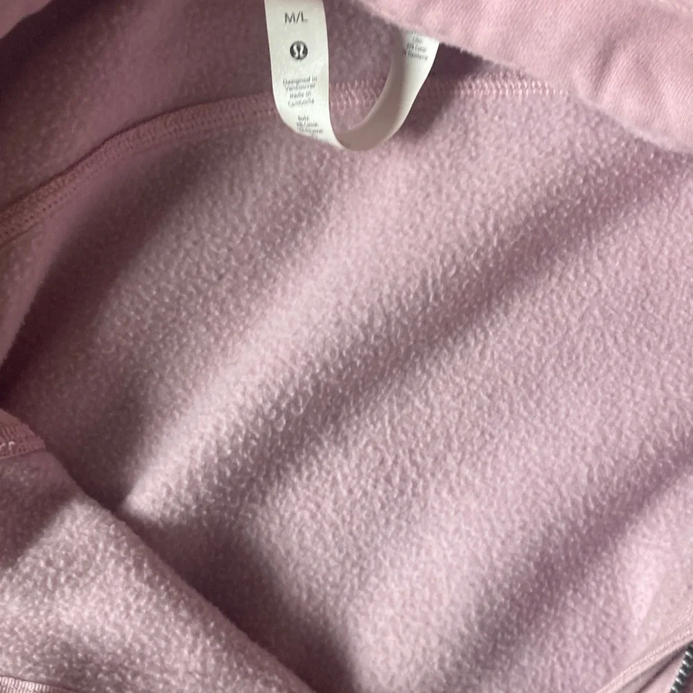 Women's jacket tag inside a pink hoodie
